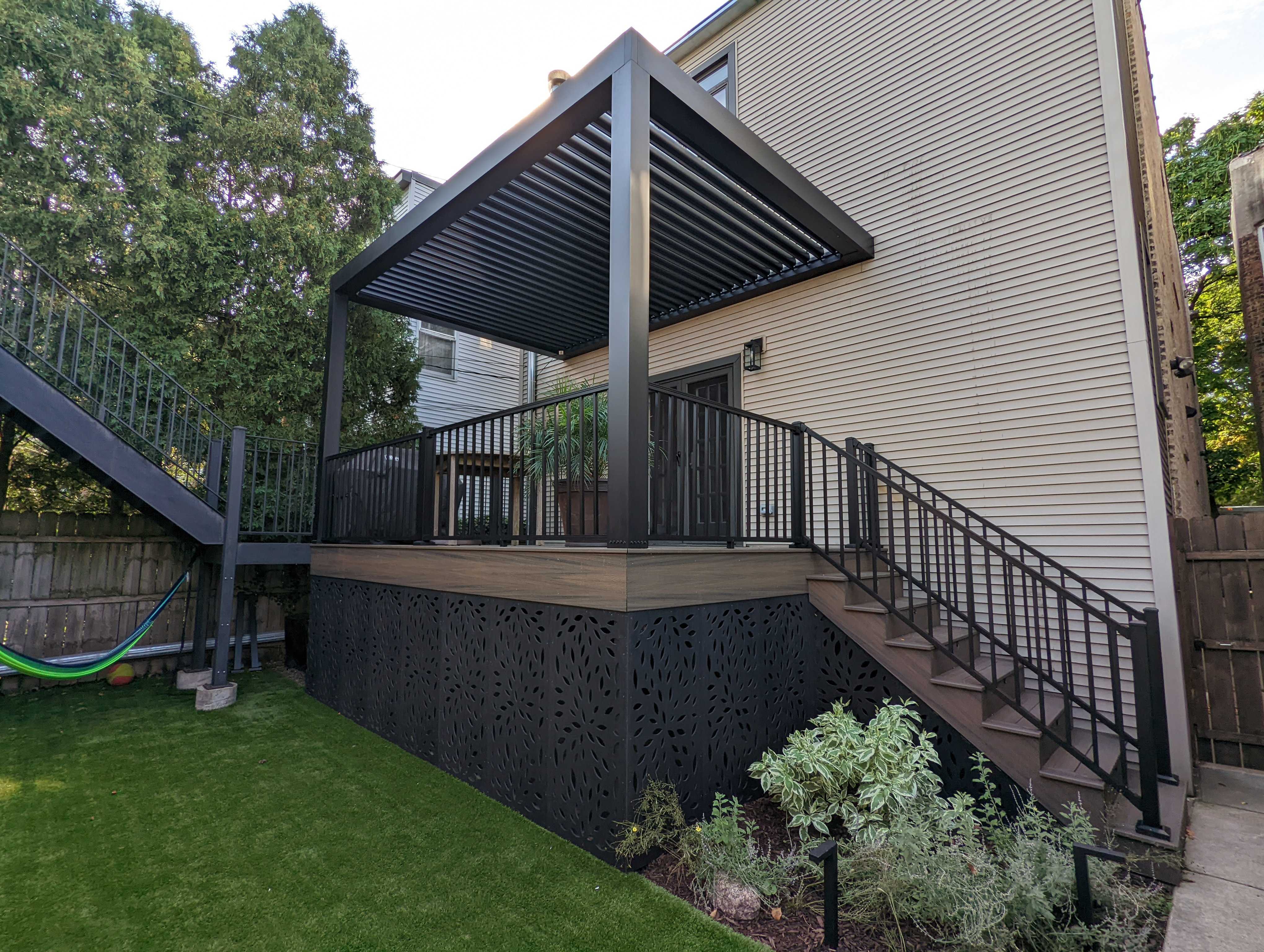 A covered deck with a pergola-style roof and vinyl lattice skirting below
