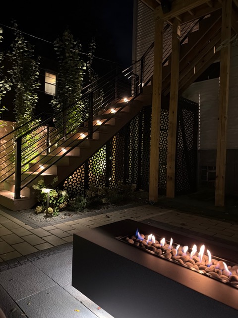 Patio stairs glowing at dusk, lined with Acurio lattice panels